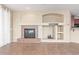 Comfortable living room with a fireplace, built-in shelving, and tile flooring leading to an adjacent room at 4116 W Milada Dr, Laveen, AZ 85339