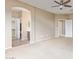 Expansive main bedroom with ceiling fan, neutral walls, and entrances to the bathroom and closet at 4116 W Milada Dr, Laveen, AZ 85339