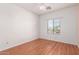 Bright bedroom with ceiling fan, laminate floors, and window letting in natural light at 599 W Agrarian Hills Dr, San Tan Valley, AZ 85143