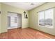 Well-lit bedroom featuring laminate wood flooring, window, and an organized closet space at 599 W Agrarian Hills Dr, San Tan Valley, AZ 85143