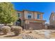 Two-story home with a two-car garage, desert rock landscape, and neutral stucco facade at 599 W Agrarian Hills Dr, San Tan Valley, AZ 85143