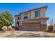 Two-story home featuring a two-car garage, low-maintenance landscaping, and desert rock yard at 599 W Agrarian Hills Dr, San Tan Valley, AZ 85143