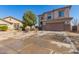 Two-story home featuring a two-car garage, desert-style landscaping, and neutral colored stucco at 599 W Agrarian Hills Dr, San Tan Valley, AZ 85143