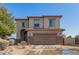 Attractive two-story home featuring a two-car garage and neutral stucco exterior with easy-care landscaping at 599 W Agrarian Hills Dr, San Tan Valley, AZ 85143