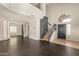 Spacious living room featuring gray flooring, soaring ceilings, and staircase to the second floor at 599 W Agrarian Hills Dr, San Tan Valley, AZ 85143