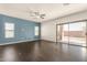 Bright living room boasts dark wood-look floors and a sliding glass door to the backyard at 599 W Agrarian Hills Dr, San Tan Valley, AZ 85143