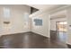 Open living room showcasing high ceilings, natural light from the clerestory windows, and gray flooring at 599 W Agrarian Hills Dr, San Tan Valley, AZ 85143