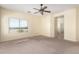 Spacious carpeted living room with a large window offering outdoor views and natural light at 599 W Agrarian Hills Dr, San Tan Valley, AZ 85143