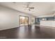 Open-concept living room features dark wood-look floors and backyard access, flowing into the adjacent kitchen at 599 W Agrarian Hills Dr, San Tan Valley, AZ 85143