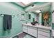 Stylish bathroom featuring a modern bowl sink, vanity with storage, and decorative mirrors at 6217 W Orange Dr, Glendale, AZ 85301