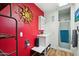 Bathroom with a red accent wall, sink, and a walk-in shower with a glass door at 6217 W Orange Dr, Glendale, AZ 85301