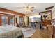 Bright bedroom with an entertainment center, ceiling fan, and tile flooring at 6217 W Orange Dr, Glendale, AZ 85301