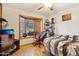 A cozy bedroom with natural light, featuring a gamer-style chair and decorative window sill art at 6217 W Orange Dr, Glendale, AZ 85301