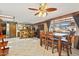 Open dining area featuring a ceiling fan, tile flooring, and a view of the backyard at 6217 W Orange Dr, Glendale, AZ 85301