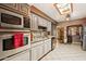 Well-lit kitchen features stainless steel appliances, white cabinets, and a tile backsplash at 6217 W Orange Dr, Glendale, AZ 85301