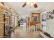 Large tiled living space featuring a wet bar, exercise equipment, and open floor plan at 6217 W Orange Dr, Glendale, AZ 85301