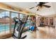 Workout room with large windows overlooking the pool, treadmill, and exercise equipment at 6217 W Orange Dr, Glendale, AZ 85301