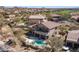 Stunning aerial view of home with private pool, lush backyard, and golf course community at 7418 E Sandia Cir, Mesa, AZ 85207