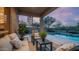 Relaxing covered back patio with cozy seating area, view of the pool, and outdoor spiral staircase at 7418 E Sandia Cir, Mesa, AZ 85207