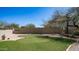 The backyard has a charming putting green and desert landscaping offering a private retreat at 7418 E Sandia Cir, Mesa, AZ 85207