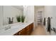 Bathroom featuring a double sink vanity with a large mirror and a tiled floor at 7418 E Sandia Cir, Mesa, AZ 85207