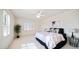 Bedroom with a king-sized bed, shuttered windows, ceiling fan, and neutral décor at 7418 E Sandia Cir, Mesa, AZ 85207