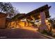 Elegant entryway featuring stone pillars, wood beams, and warm lighting, creating a welcoming ambiance for residents and guests at 7418 E Sandia Cir, Mesa, AZ 85207