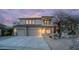 Inviting two-story home with a three-car garage, a tile roof, and desert landscaping in the front yard at 7418 E Sandia Cir, Mesa, AZ 85207