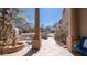 Covered front patio with tiled floors, stone pillars, a water feature, and inviting outdoor seating at 7418 E Sandia Cir, Mesa, AZ 85207