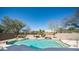 The backyard pool has a rock waterfall and desert landscaping providing a tranquil oasis at 7418 E Sandia Cir, Mesa, AZ 85207