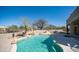 Resort-style pool features rock accents and a built-in barbecue for ultimate outdoor entertaining at 7418 E Sandia Cir, Mesa, AZ 85207