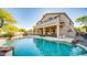 Inviting backyard pool with spiral staircase access to the upper balcony and an outdoor kitchen area at 7418 E Sandia Cir, Mesa, AZ 85207