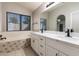 Bathroom features a double sink vanity, tiled floors, and a separate bathtub at 830 N Cholla St, Chandler, AZ 85224