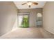 Neutral bedroom with a ceiling fan, carpet, and a door to the outside at 830 N Cholla St, Chandler, AZ 85224