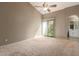 Neutral bedroom with a ceiling fan, carpet, and a door to the outside at 830 N Cholla St, Chandler, AZ 85224