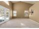 Bright living area with a high ceiling, carpeted floors, patio access, and large windows offering plenty of natural light at 830 N Cholla St, Chandler, AZ 85224