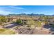 Aerial view highlighting community buildings, beautiful desert landscaping, and mountain views at 9100 E Raintree Dr # 209, Scottsdale, AZ 85260