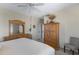 Bright bedroom with a ceiling fan, complemented by wooden dresser and a view of the outdoors at 9100 E Raintree Dr # 209, Scottsdale, AZ 85260