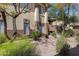 Exterior community view showing nice landscaping, trees, and beige stucco building at 9100 E Raintree Dr # 209, Scottsdale, AZ 85260