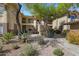 Attractive exterior view of the Raintree Casitas community featuring mature desert landscaping at 9100 E Raintree Dr # 209, Scottsdale, AZ 85260