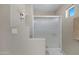 Neutral colored bathroom featuring a step up to a tiled shower with glass doors at 9100 E Raintree Dr # 209, Scottsdale, AZ 85260