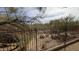 View of the desert landscape with trees and plants, as seen from behind a backyard fence at 9435 E Mohawk Ln, Scottsdale, AZ 85255