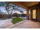 Inviting covered patio overlooking backyard, pool, waterfall, fire pit, and desert landscaping at 9435 E Mohawk Ln, Scottsdale, AZ 85255