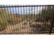 Backyard view through the fence, revealing natural desert landscape at 9435 E Mohawk Ln, Scottsdale, AZ 85255