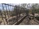 View of a backyard iron fence with landscaping and rocky ground at 9435 E Mohawk Ln, Scottsdale, AZ 85255