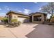 Charming home exterior with a two-car garage, desert landscaping, and inviting curb appeal at 9435 E Mohawk Ln, Scottsdale, AZ 85255