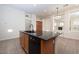 Kitchen island with granite countertop, black appliances, and tile flooring at 9435 E Mohawk Ln, Scottsdale, AZ 85255