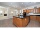 Well-appointed kitchen featuring granite countertops, a kitchen island, and sleek appliances at 9435 E Mohawk Ln, Scottsdale, AZ 85255