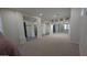 Spacious living room with neutral carpet, white columns, and a wall of mirrors that amplify the space at 9435 E Mohawk Ln, Scottsdale, AZ 85255