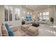 Inviting living room featuring a neutral color palette and large windows with plantation shutters at 9435 E Mohawk Ln, Scottsdale, AZ 85255